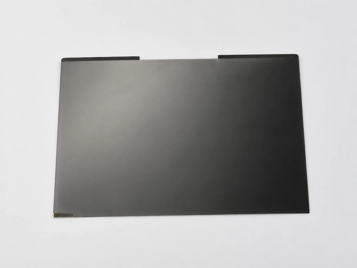 Privacy filter with dark attachment strips along its top edge.